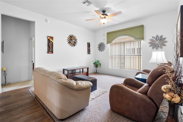 living room featuring ceiling fan and hardwood / wood-style flooring