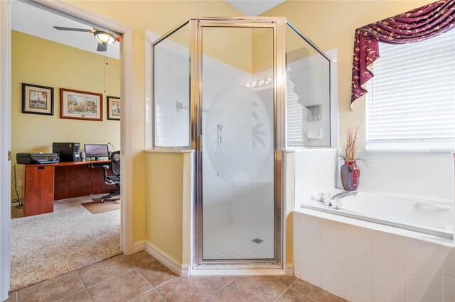 bathroom with a garden tub, a shower stall, a ceiling fan, and tile patterned floors