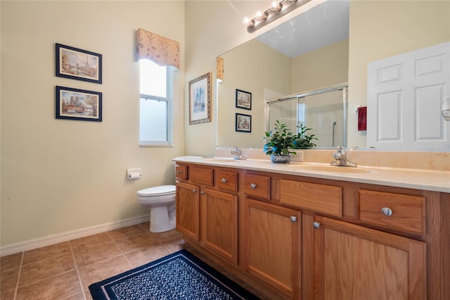 bathroom with toilet, dual vanity, and tile patterned floors