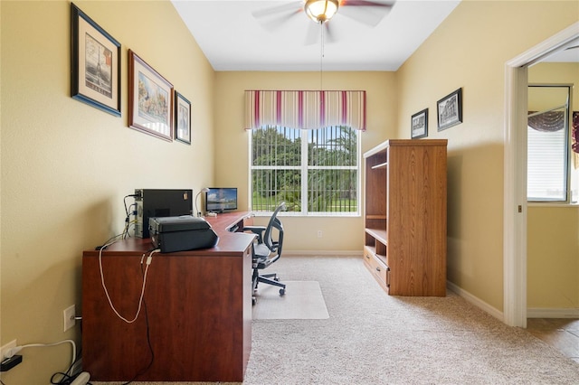 carpeted office space featuring ceiling fan