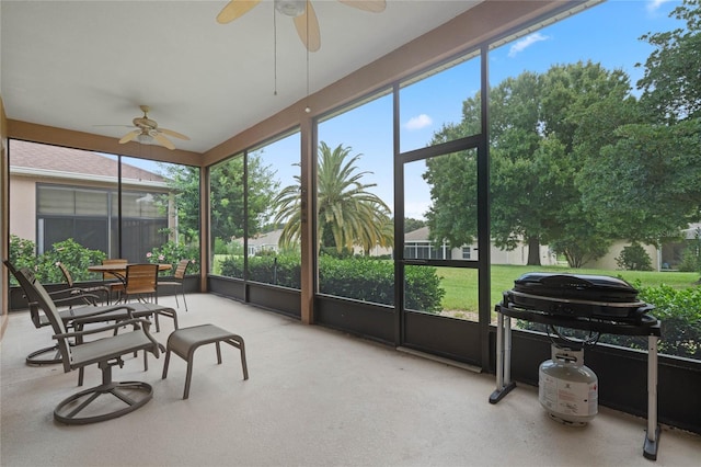 sunroom / solarium featuring ceiling fan