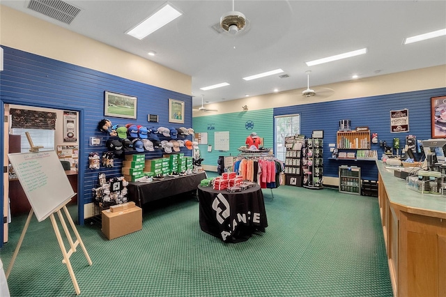 rec room with visible vents, a ceiling fan, and carpet flooring