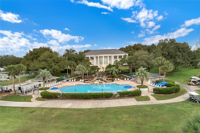 view of pool with a lawn and a patio