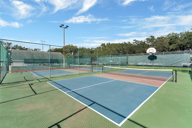 view of sport court with basketball hoop