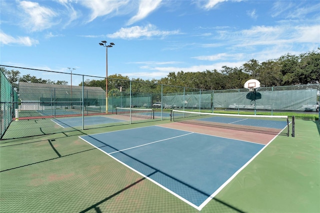 view of sport court featuring community basketball court and fence