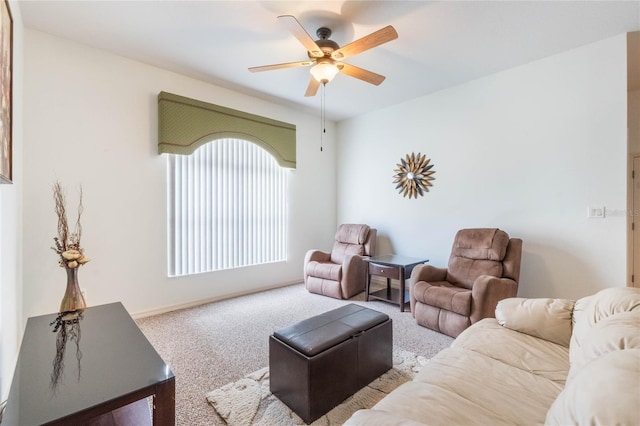 living room featuring a ceiling fan, carpet flooring, and baseboards