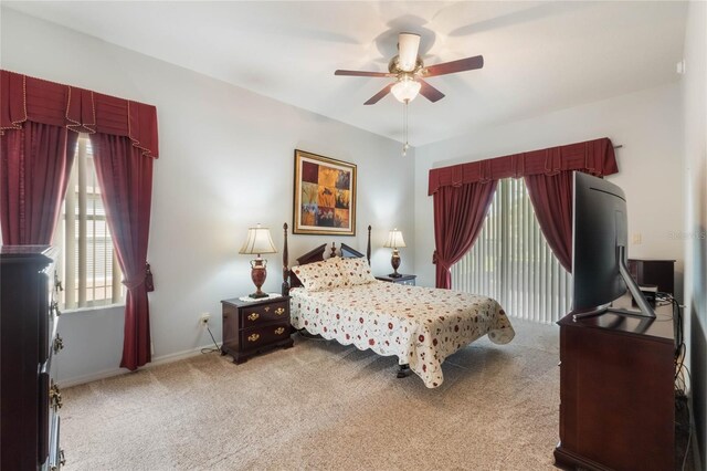 bedroom featuring a ceiling fan and light colored carpet