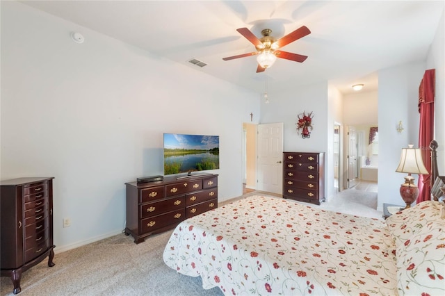 bedroom featuring visible vents, baseboards, ceiling fan, ensuite bathroom, and carpet