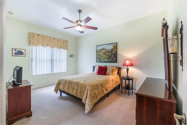 bedroom with ceiling fan, carpet, and baseboards