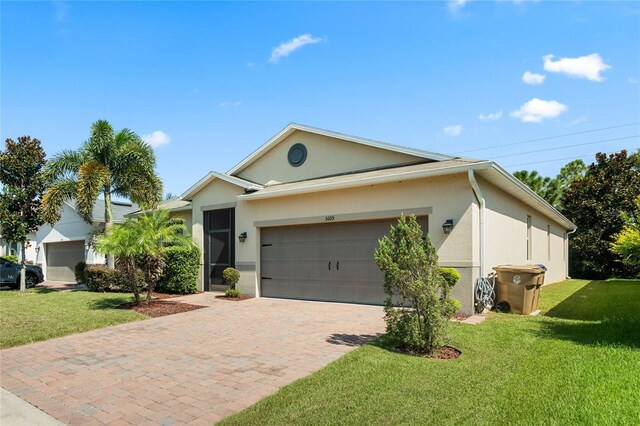 single story home with a front yard and a garage