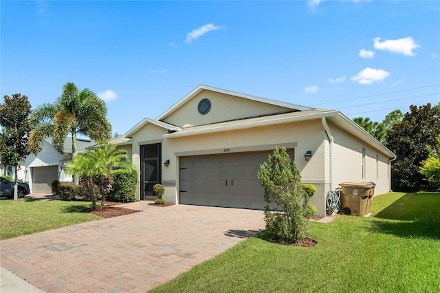 ranch-style house featuring an attached garage, decorative driveway, a front yard, and stucco siding