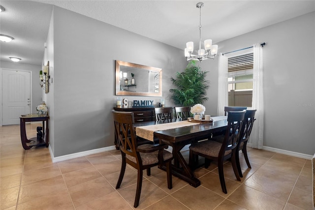 tiled dining area with a notable chandelier