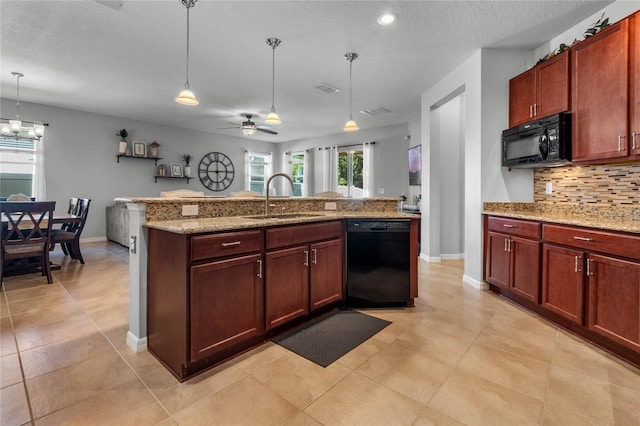 kitchen with black appliances, backsplash, a sink, and pendant lighting