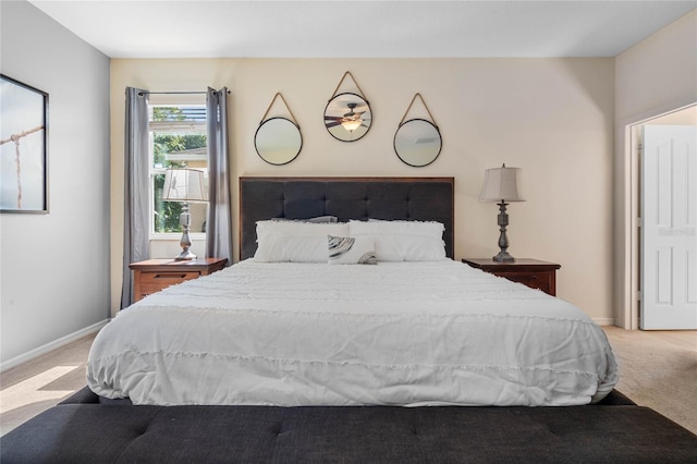 bedroom with light carpet and baseboards