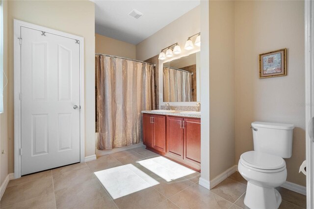 bathroom featuring toilet, tile patterned floors, and vanity