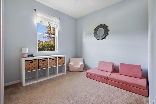 sitting room featuring ceiling fan and carpet floors