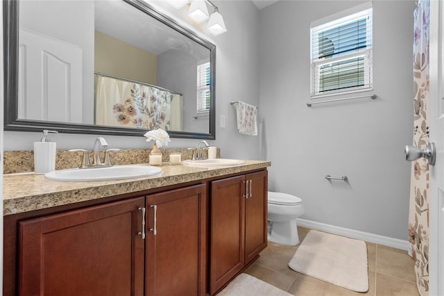 bathroom featuring plenty of natural light, tile patterned flooring, and a sink