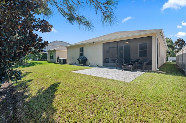 back of property with a lawn, central AC unit, a sunroom, a patio area, and fence