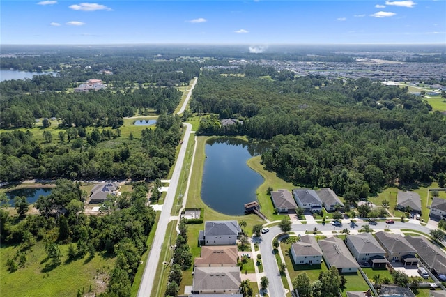 birds eye view of property featuring a residential view, a water view, and a wooded view