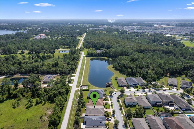 birds eye view of property featuring a residential view, a water view, and a forest view