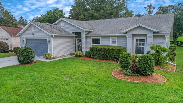 ranch-style house with a garage and a front yard