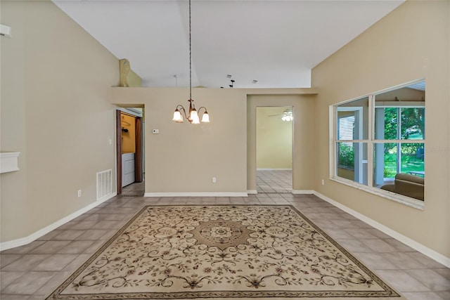 unfurnished dining area featuring ceiling fan with notable chandelier and light tile patterned floors