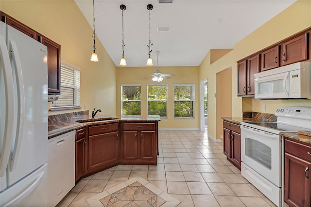 kitchen with vaulted ceiling, sink, light tile patterned floors, white appliances, and ceiling fan