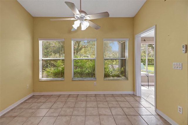 unfurnished room featuring light tile patterned floors, baseboards, and a wealth of natural light