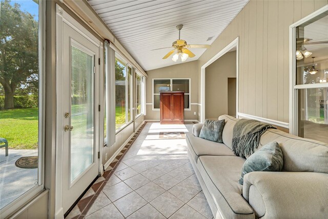 sunroom with ceiling fan and vaulted ceiling