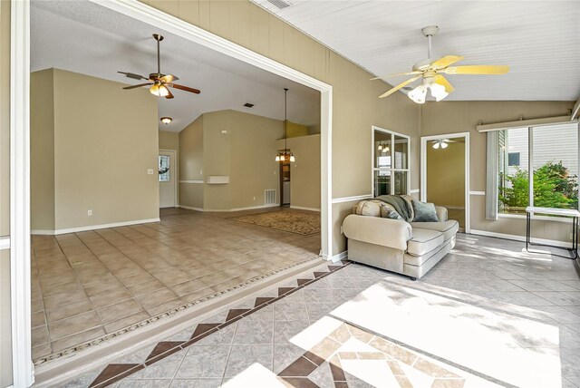 unfurnished living room featuring ceiling fan, lofted ceiling, and light tile patterned flooring