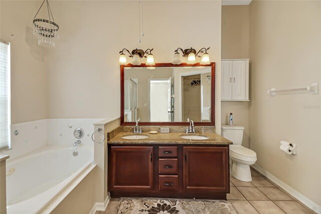 bathroom featuring a tub, tile patterned flooring, double vanity, and toilet