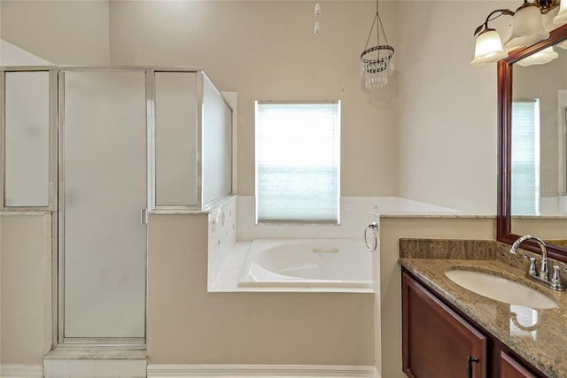 bathroom featuring a garden tub, vanity, and a shower stall