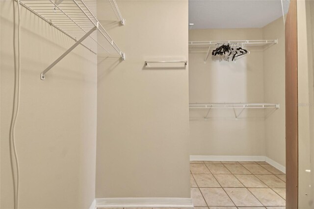 spacious closet featuring light tile patterned flooring