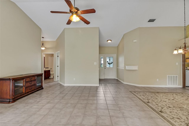 unfurnished living room with light tile patterned floors, ceiling fan with notable chandelier, and lofted ceiling