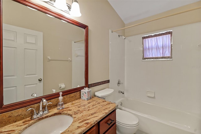 bathroom with washtub / shower combination, vanity, and toilet