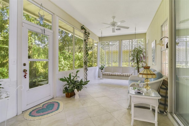 sunroom featuring ceiling fan