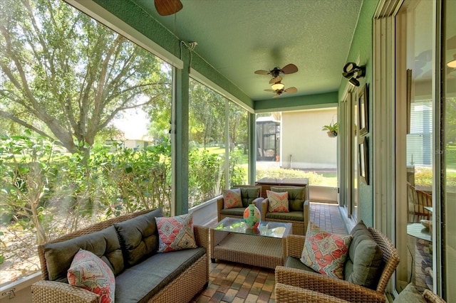 sunroom featuring ceiling fan