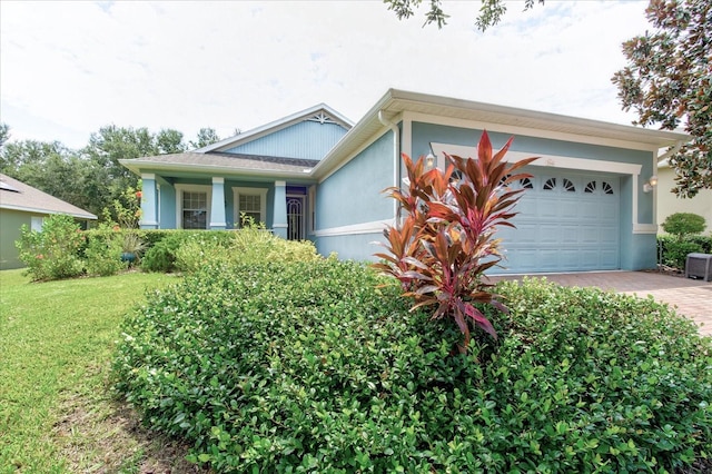 view of front of property with a garage and a front yard