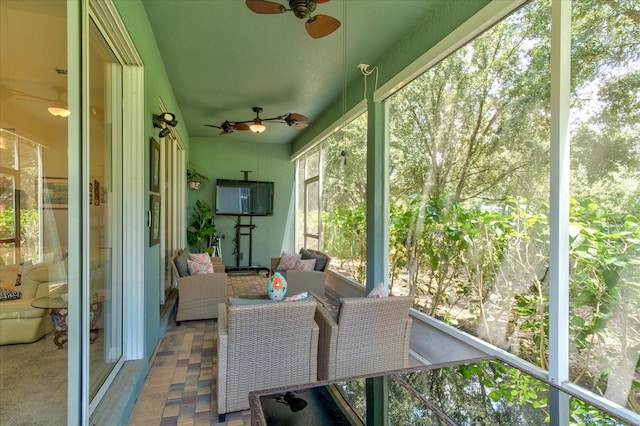 sunroom / solarium with ceiling fan