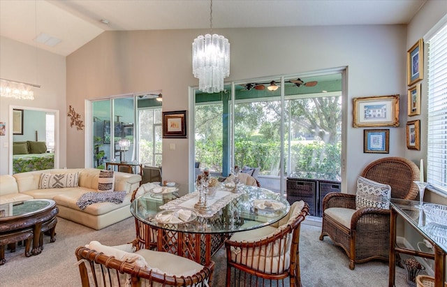 carpeted dining area featuring vaulted ceiling and an inviting chandelier