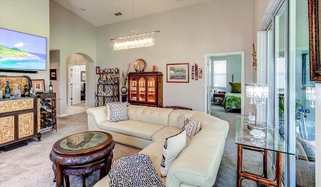 carpeted living room featuring a high ceiling