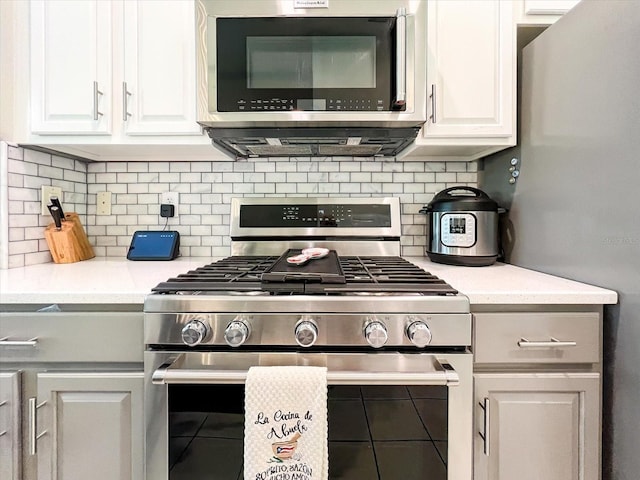 kitchen with tasteful backsplash, white cabinetry, and stainless steel appliances