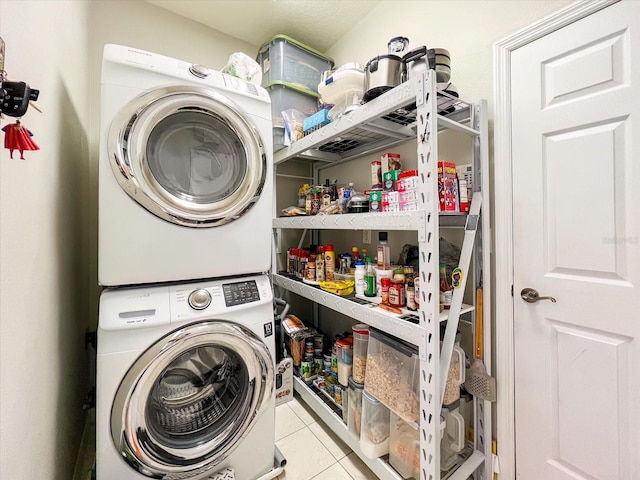 washroom featuring light tile patterned flooring and stacked washer and clothes dryer