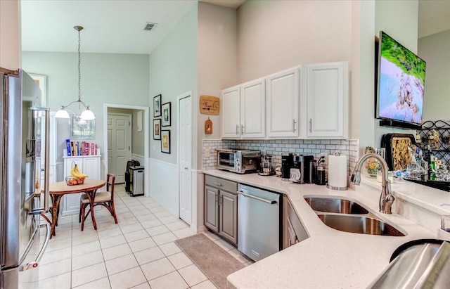 kitchen with backsplash, stainless steel appliances, sink, high vaulted ceiling, and light tile patterned floors