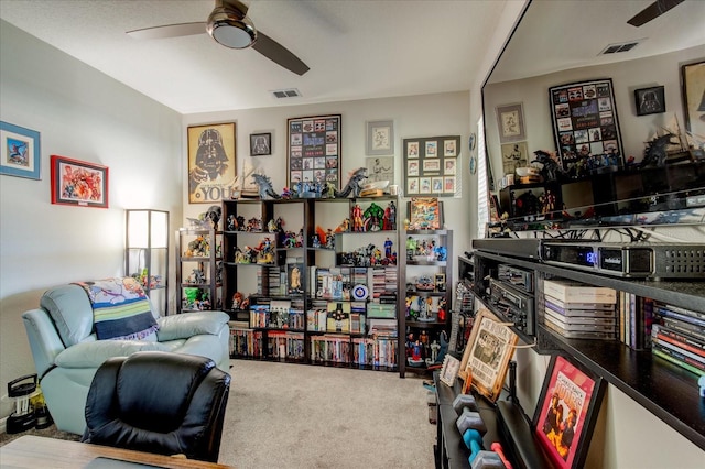 sitting room with carpet flooring and ceiling fan