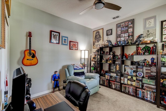 exercise area featuring ceiling fan and carpet