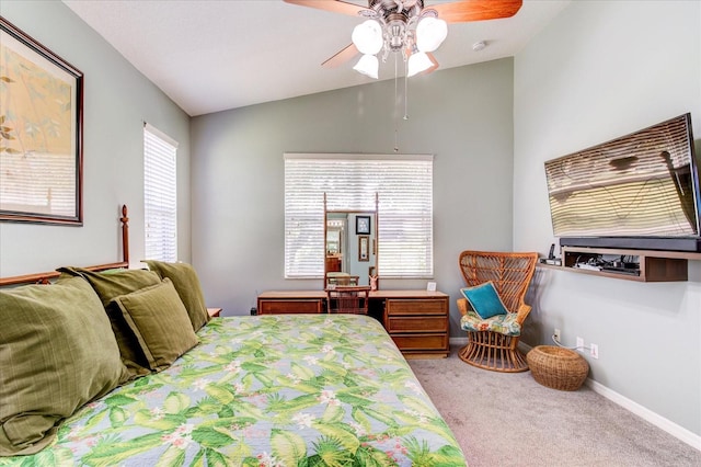 bedroom with ceiling fan, vaulted ceiling, and carpet floors