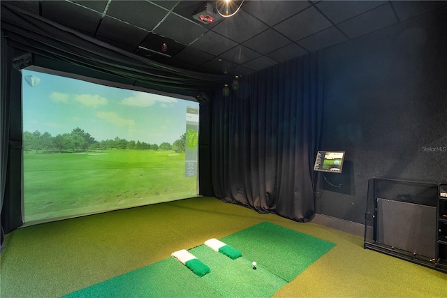 playroom with a drop ceiling, carpet floors, and golf simulator