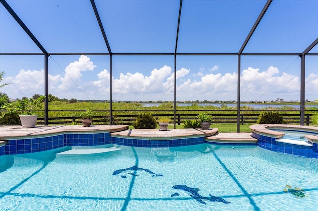 view of swimming pool featuring an in ground hot tub and a lanai