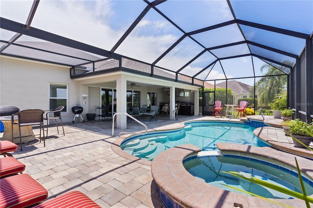 view of swimming pool with ceiling fan, a lanai, an in ground hot tub, an outdoor hangout area, and a patio area